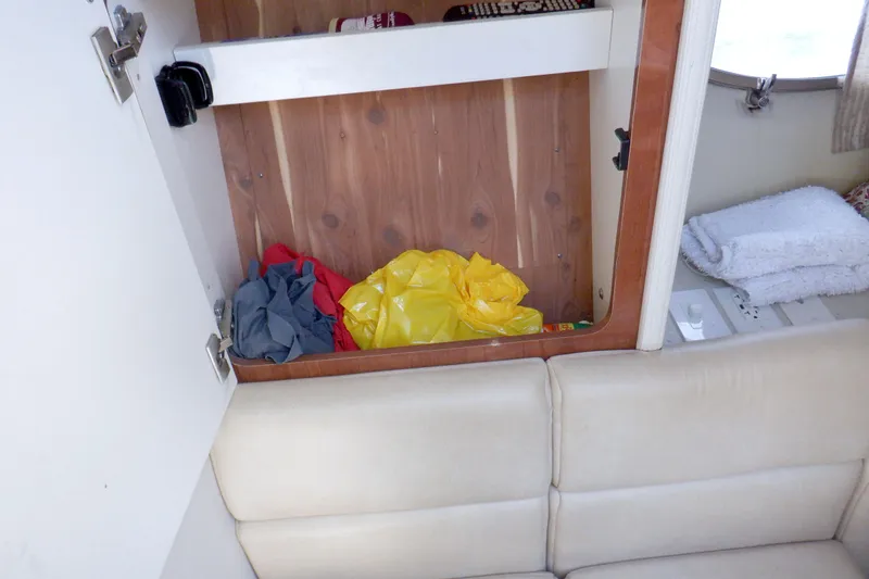 Ship Faced Yacht Photos Pics 2015 Formula 350 Crossover Bowrider interior storage with colorful bags and towels.