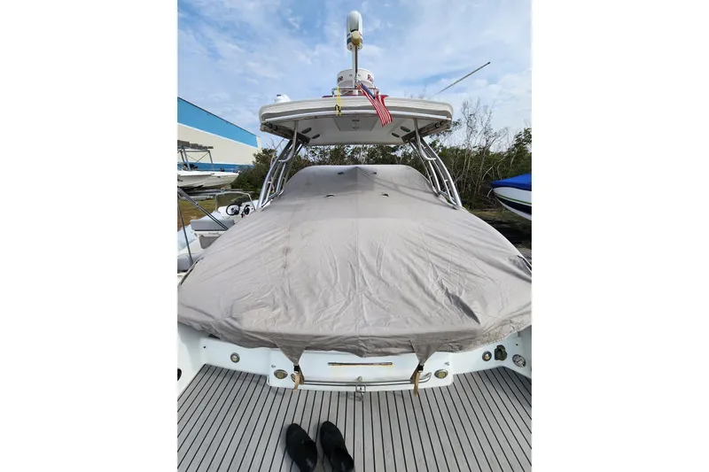 Ship Faced Yacht Photos Pics 2015 Formula 350 Crossover Bowrider covered, docked with American flag, clear sky background.
