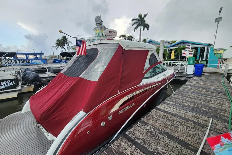 Ship Faced Yacht Photos Pics 2015 Formula 350 Crossover Bowrider docked with red cover and American flag.