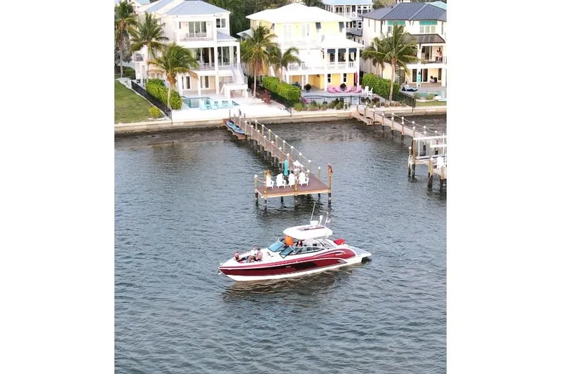 Ship Faced Yacht Photos Pics 2015 Formula 350 Crossover Bowrider cruising near waterfront homes and docks.