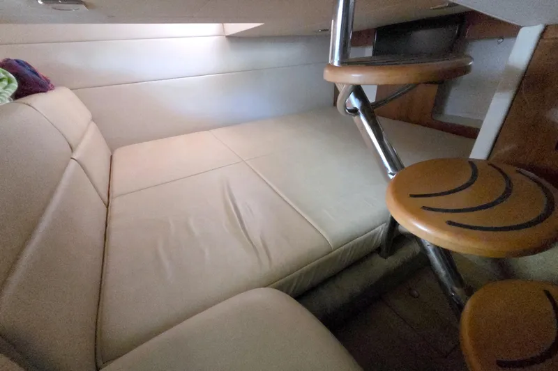 Ship Faced Yacht Photos Pics 2015 Formula 350 Crossover Bowrider cabin interior with beige seating and wooden steps.