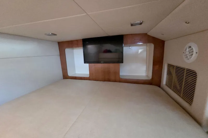 Ship Faced Yacht Photos Pics 2015 Formula 350 Crossover Bowrider cabin interior with TV and wood paneling.