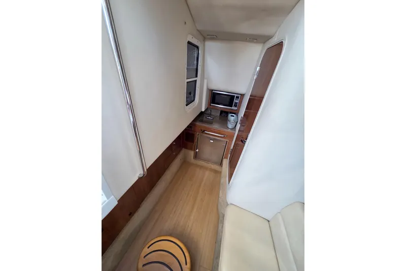 Ship Faced Yacht Photos Pics 2015 Formula 350 Crossover Bowrider interior with kitchenette and seating area.