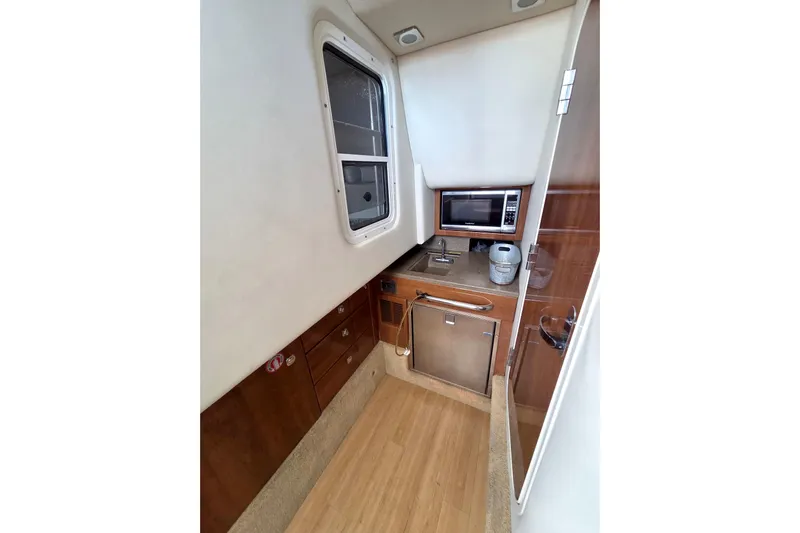 Ship Faced Yacht Photos Pics 2015 Formula 350 Crossover Bowrider interior kitchen with microwave and sink.