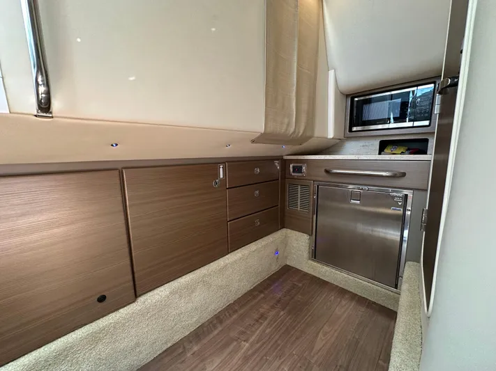  Yacht Photos Pics 2019 Formula 350 Crossover Bowrider cabin interior with wood cabinetry and stainless steel appliances.
