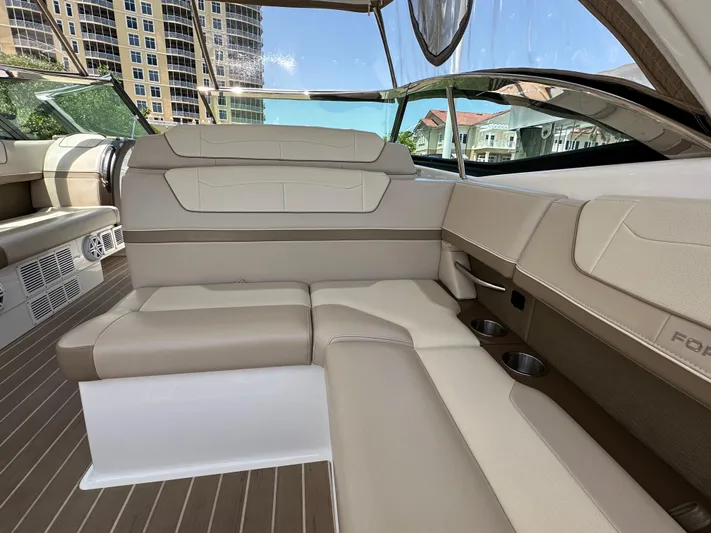 Yacht Photos Pics 2019 Formula 350 Crossover Bowrider interior with beige seating and cup holders.