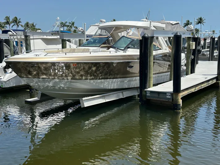  Yacht Photos Pics 2019 Formula 350 Crossover Bowrider docked at marina, reflecting on calm water.