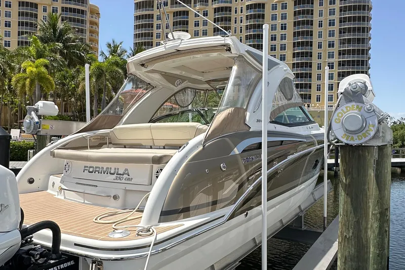  Yacht Photos Pics 2019 Formula 350 Crossover Bowrider docked near luxury buildings and palm trees.