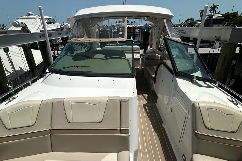  Yacht Photos Pics 2019 Formula 350 Crossover Bowrider at dock, featuring spacious seating and sleek design.
