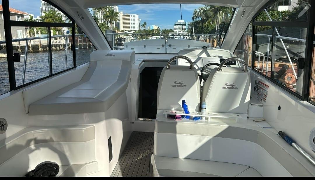 Interior view of 2021 Evolve 400HT yacht, featuring sleek seating and modern design.