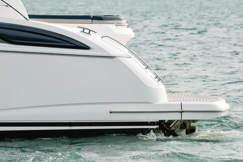  Yacht Photos Pics 2022 Princess V50 yacht stern on water, showcasing sleek design and elegance.
