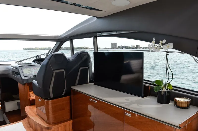  Yacht Photos Pics Luxurious 2022 Princess V50 yacht interior with helm, TV, and elegant decor.