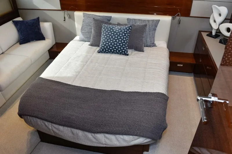  Yacht Photos Pics Luxurious bedroom interior on a 2022 Princess V50 yacht, featuring elegant bedding and decor.