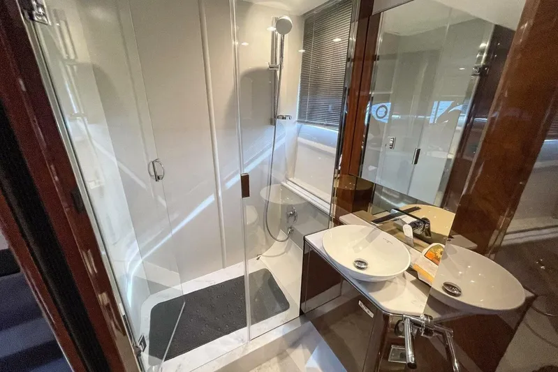  Yacht Photos Pics Luxurious bathroom in 2022 Princess V50 yacht with modern shower and dual sinks.