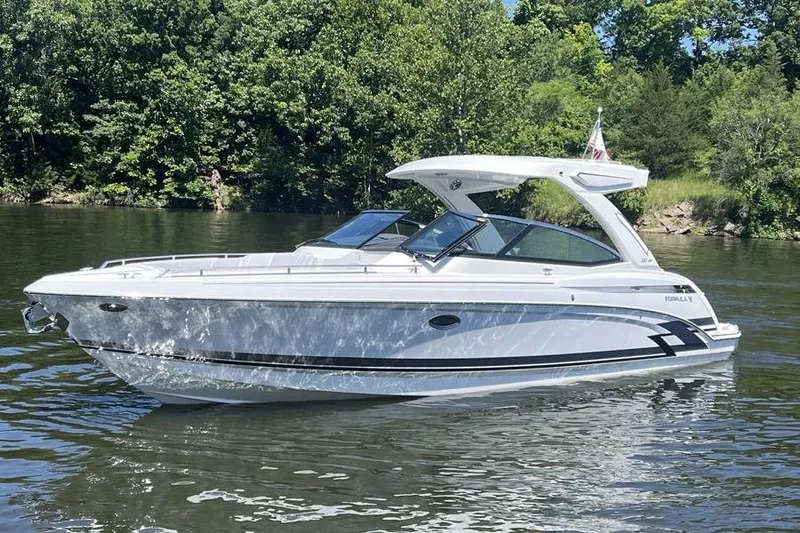 330cbr Yacht Photos Pics 2025 Formula 330 Crossover Bowrider I/O on a serene lake.
