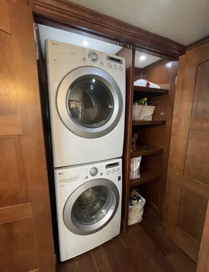  Yacht Photos Pics Stacked washer and dryer in wooden closet on Stardust Cruisers houseboat.