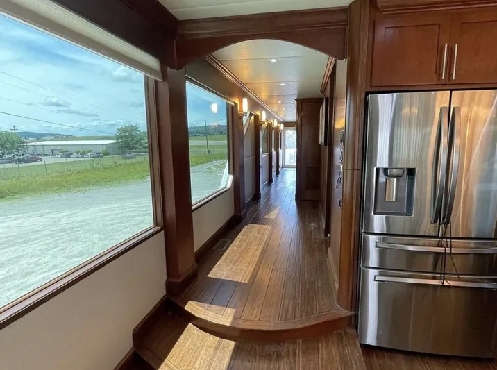  Yacht Photos Pics Interior of 2015 Stardust Cruisers 20' x 106' houseboat with wooden floors and stainless steel appliances.