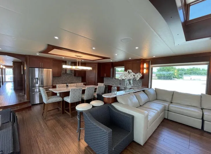  Yacht Photos Pics Luxurious interior of 2015 Stardust Cruisers 20' x 106' houseboat with modern kitchen and living area.