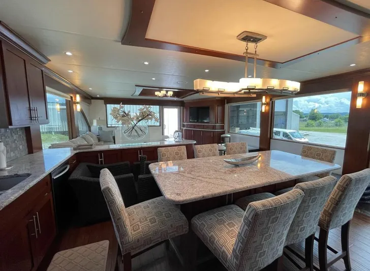  Yacht Photos Pics Luxurious interior of 2015 Stardust Cruisers 20' x 106' houseboat with modern dining area.