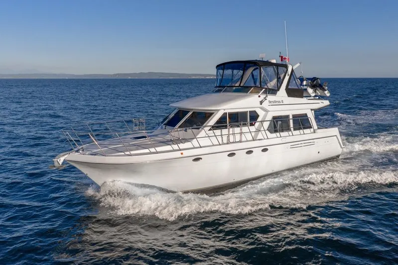 Restless II Yacht Photos Pics 2007 Navigator Classic 48 yacht cruising on open sea under clear blue sky.