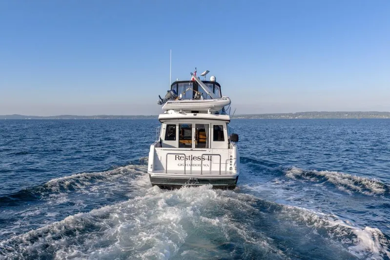 Restless II Yacht Photos Pics 2007 Navigator Classic 48 yacht cruising on open water under clear blue skies.