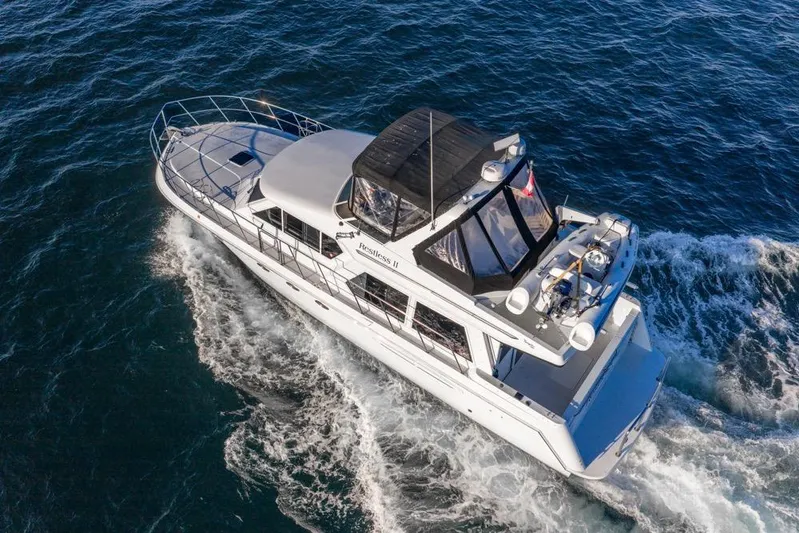 Restless II Yacht Photos Pics Aerial view of 2007 Navigator Classic 48 yacht cruising on open water.