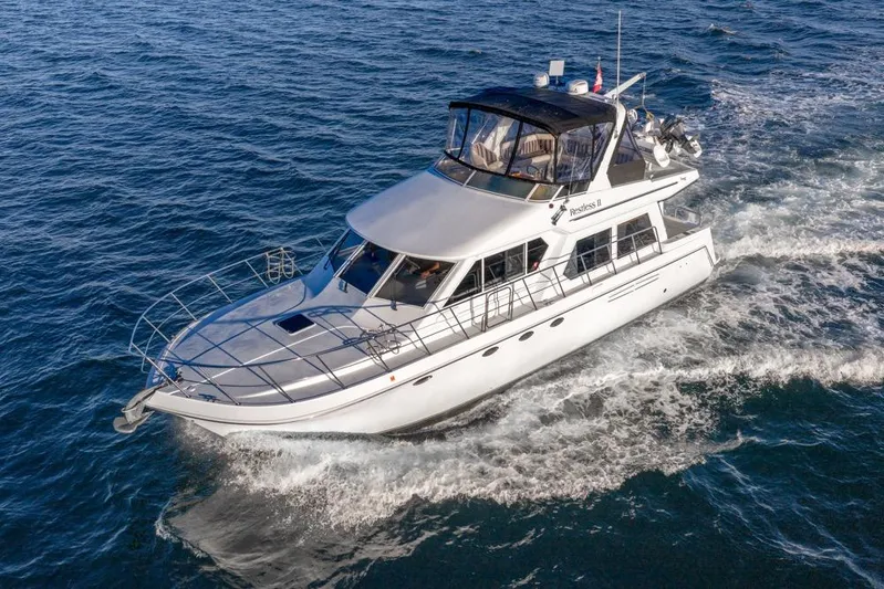 Restless II Yacht Photos Pics 2007 Navigator Classic 48 yacht cruising on open water, showcasing sleek design and luxury.