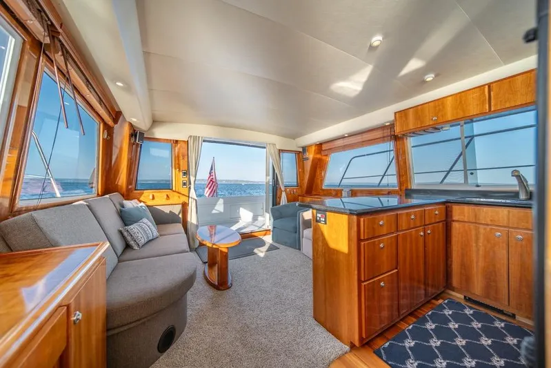 Restless II Yacht Photos Pics Luxurious interior of 2007 Navigator Classic 48 yacht with elegant wood finishes and ocean view.