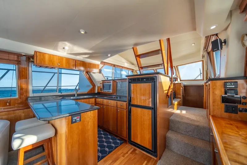 Restless II Yacht Photos Pics Luxurious 2007 Navigator Classic 48 yacht interior with wood finishes and ocean view.