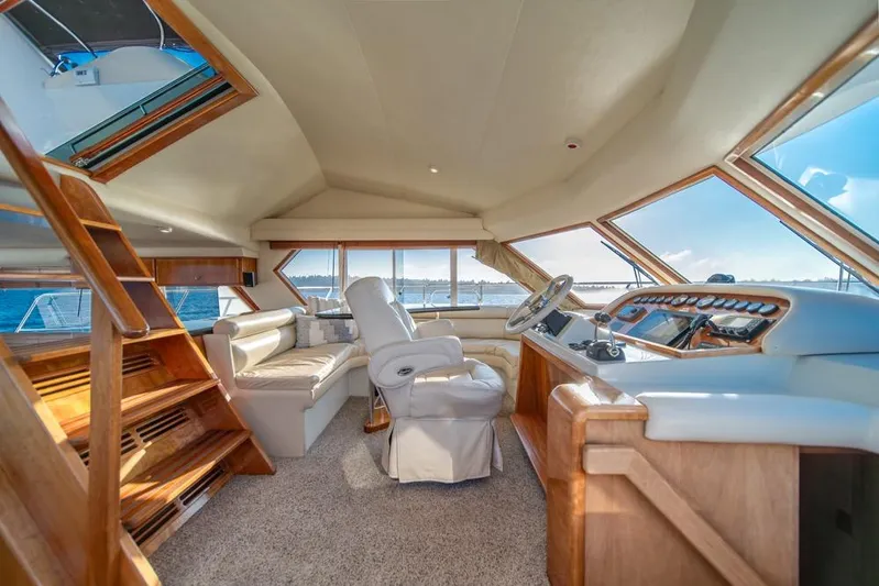 Restless II Yacht Photos Pics Luxurious interior of 2007 Navigator Classic 48 yacht with panoramic windows and plush seating.