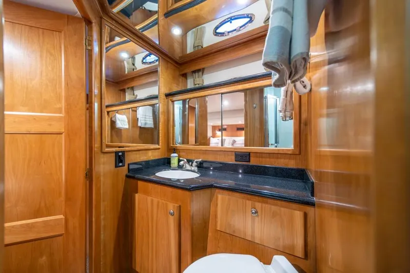 Restless II Yacht Photos Pics Luxurious bathroom interior of 2007 Navigator Classic 48 yacht with wooden cabinetry.