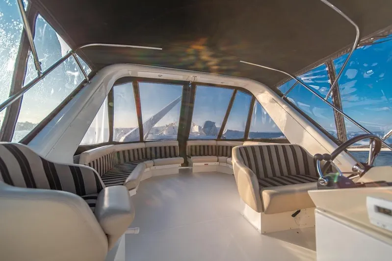 Restless II Yacht Photos Pics Luxurious interior of 2007 Navigator Classic 48 yacht with panoramic windows and striped seating.