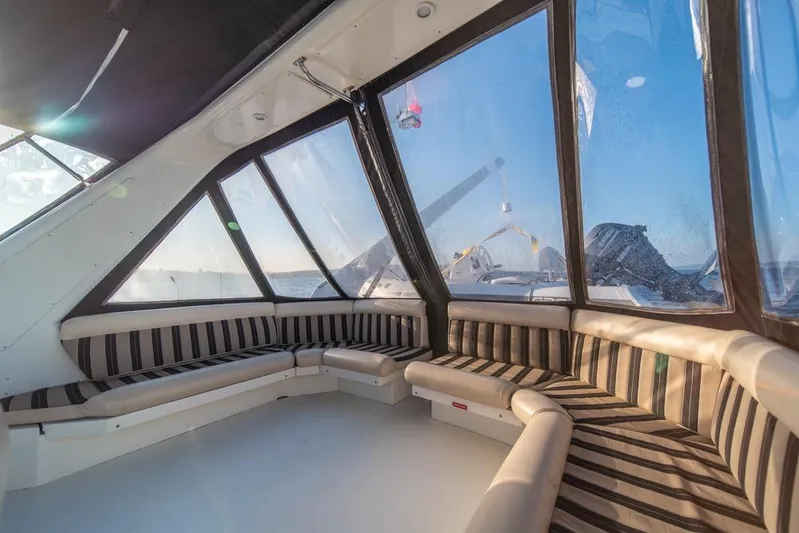 Restless II Yacht Photos Pics Interior of 2007 Navigator Classic 48 yacht with striped seating and panoramic windows.