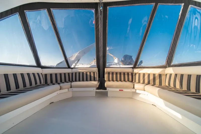 Restless II Yacht Photos Pics Luxurious interior of 2007 Navigator Classic 48 yacht with striped seating and panoramic windows.