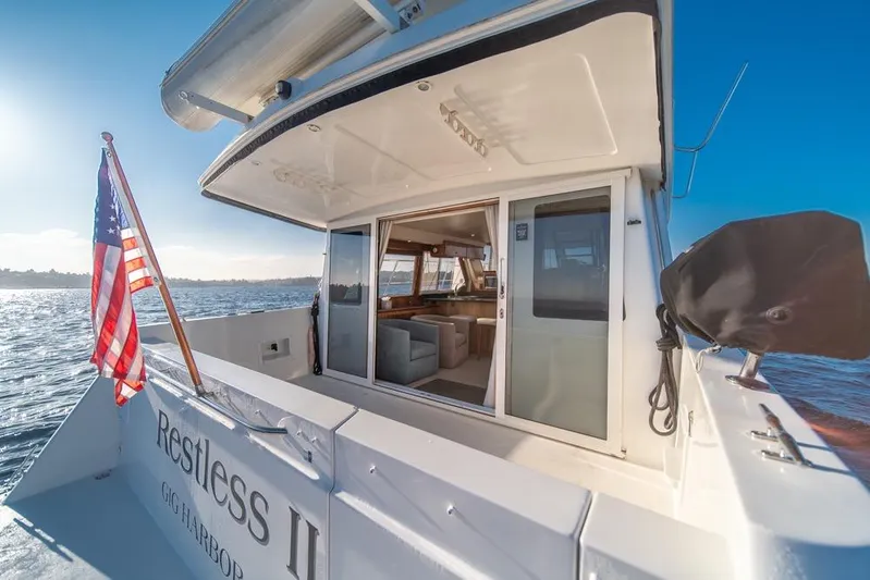 Restless II Yacht Photos Pics 2007 Navigator Classic 48 yacht with American flag, open cabin, and ocean view.