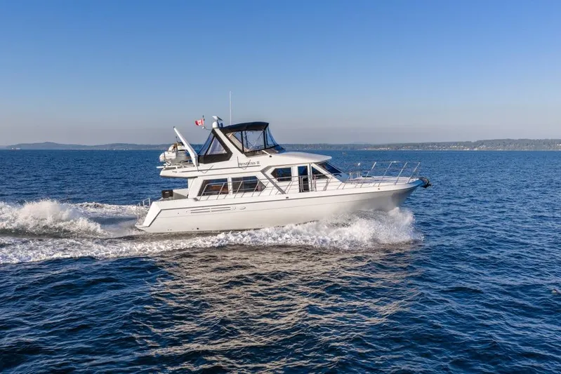 Restless II Yacht Photos Pics 2007 Navigator Classic 48 yacht cruising on open water under clear blue skies.