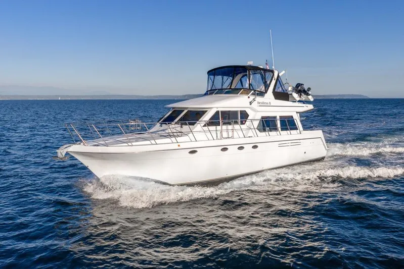 Restless II Yacht Photos Pics 2007 Navigator Classic 48 yacht cruising on open water under clear blue skies.
