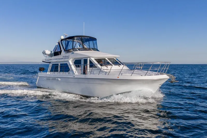 Restless II Yacht Photos Pics 2007 Navigator Classic 48 yacht cruising on open sea under clear blue sky.