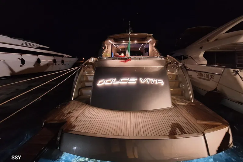  Yacht Photos Pics 2008 Pershing 72 yacht "Dolce Vita" docked at night, illuminated nameplate.