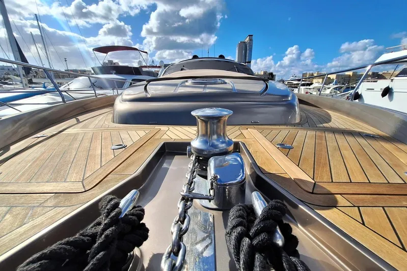 Yacht Photos Pics 2008 Pershing 72 yacht deck with polished wood and metal details under a blue sky.