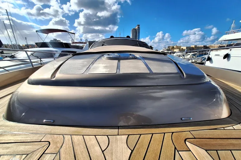  Yacht Photos Pics 2008 Pershing 72 yacht with sleek design, docked under a bright blue sky.