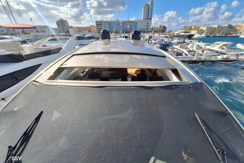  Yacht Photos Pics 2008 Pershing 72 yacht docked in a marina with cityscape background.