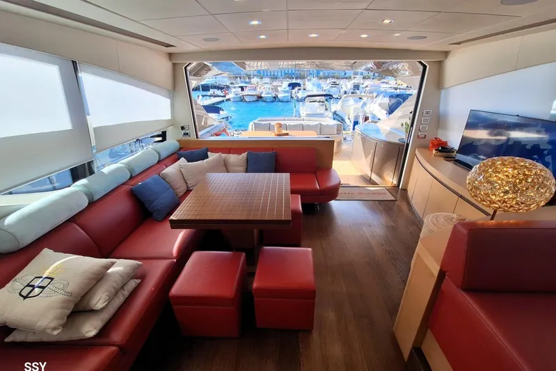  Yacht Photos Pics Luxurious interior of 2008 Pershing 72 yacht with red seating and marina view.