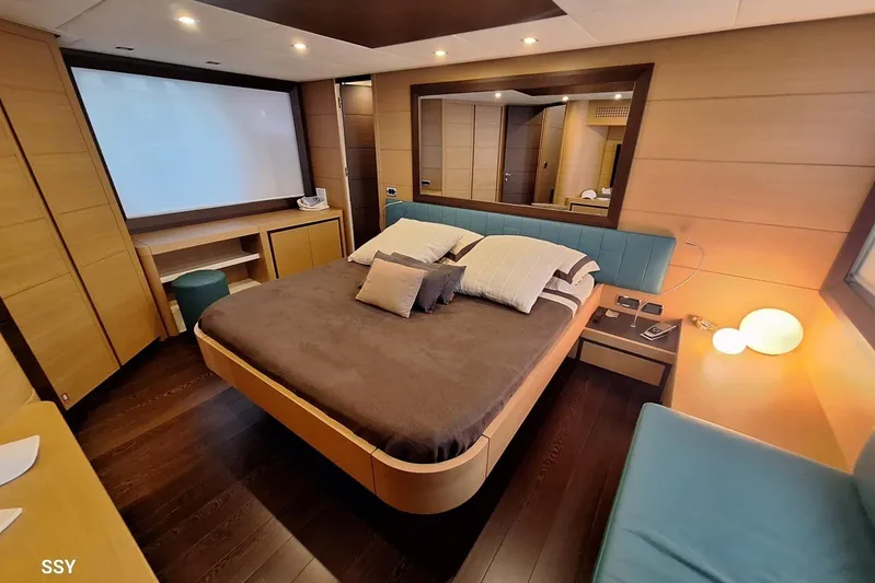  Yacht Photos Pics Luxurious bedroom interior of 2008 Pershing 72 yacht with modern design and cozy ambiance.