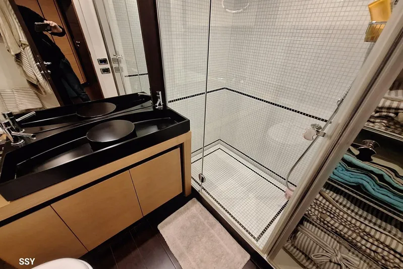  Yacht Photos Pics Luxurious bathroom in 2008 Pershing 72 yacht with modern fixtures and glass shower.