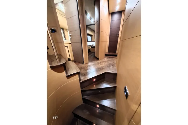  Yacht Photos Pics Luxurious interior of 2008 Pershing 72 yacht with elegant wooden staircase and modern design.