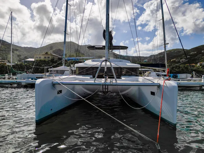 Blue Octane Yacht Photos Pics 2018 Lagoon 52 F catamaran docked in a scenic marina.