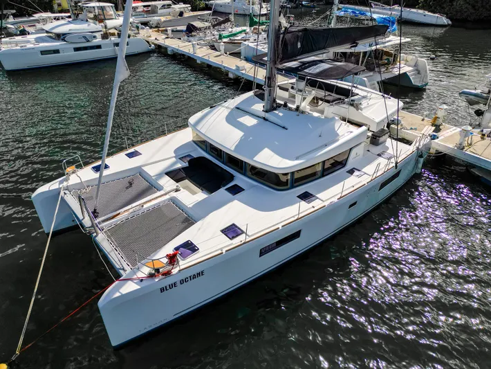 Blue Octane Yacht Photos Pics 2018 Lagoon 52 F catamaran docked at marina, aerial view.