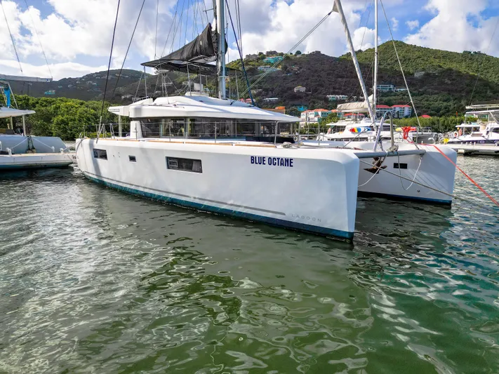 Blue Octane Yacht Photos Pics 2018 Lagoon 52 F catamaran "Blue Octane" docked in a scenic marina.