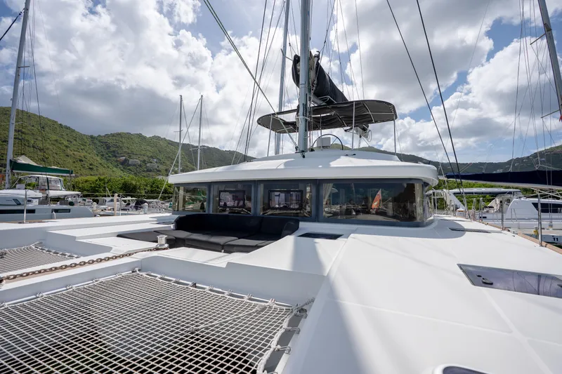 Blue Octane Yacht Photos Pics 2018 Lagoon 52 F catamaran docked, featuring spacious deck and scenic mountain backdrop.
